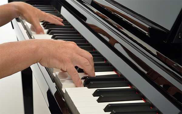 Hands Playing Piano Close Up