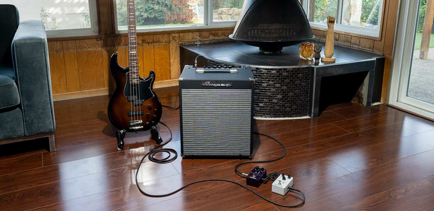 Ampeg RB-108 with Bass guitar and pedals in front of fireplace