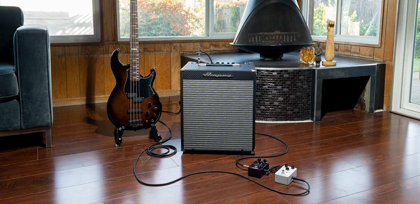 Ampeg RB-110 with Bass guitar and pedals in front of fireplace
