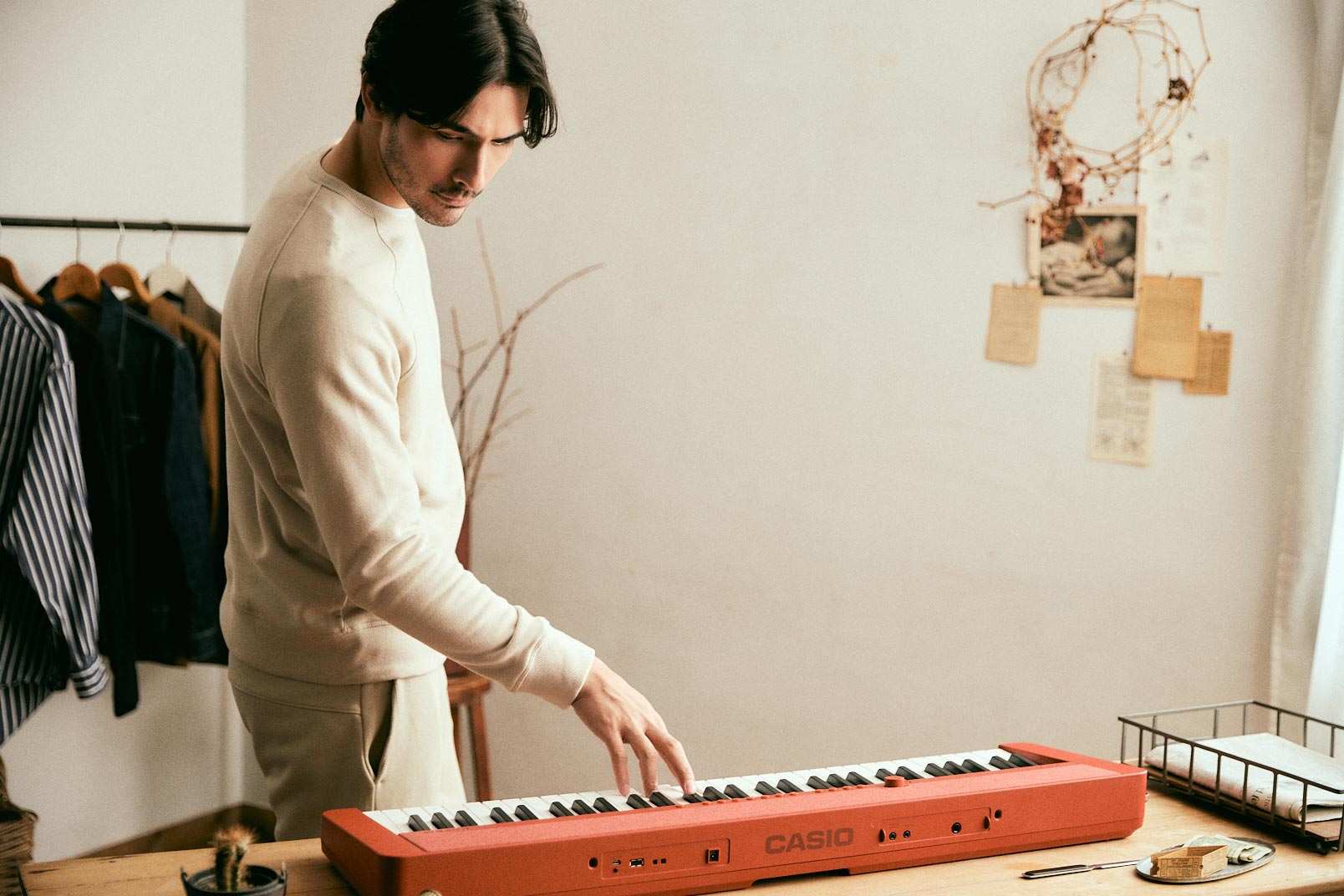 person standing next to Casio CT-S1 Red keyboard