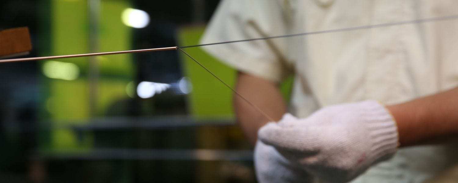 Close up detail of Yamaha Piano string winding process