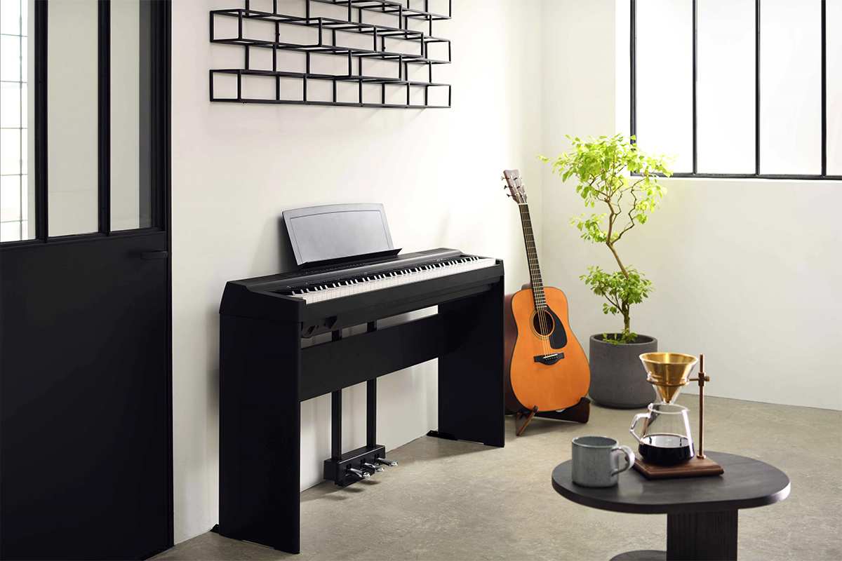 Yamaha P125a with stand against wall in modern living room