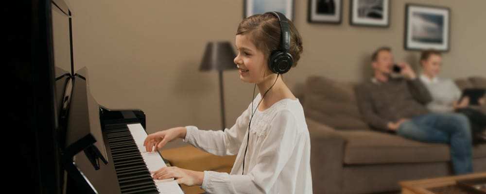 Child playing Yamaha Acoustic Piano silently with Headphones
