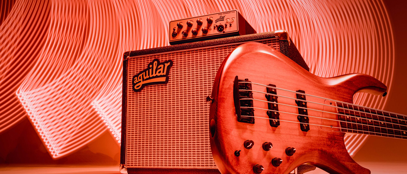 Aguilar Amplifier On Stage with Red Lighting - Brand Banner